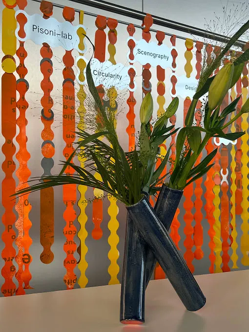 A vase with a plant in it on a table