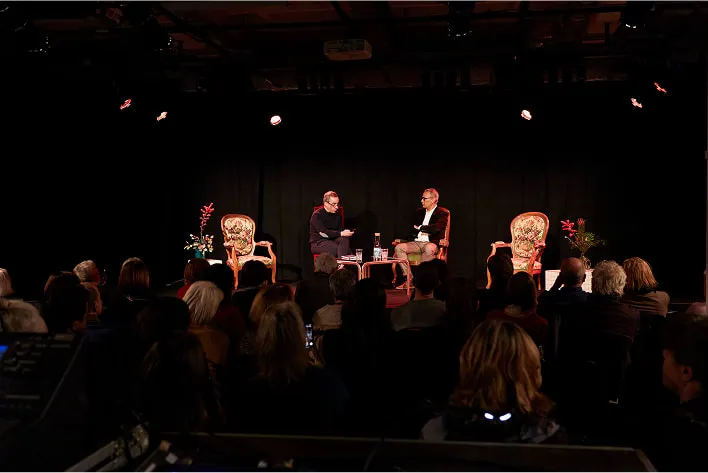 A group of people sitting on top of a stage