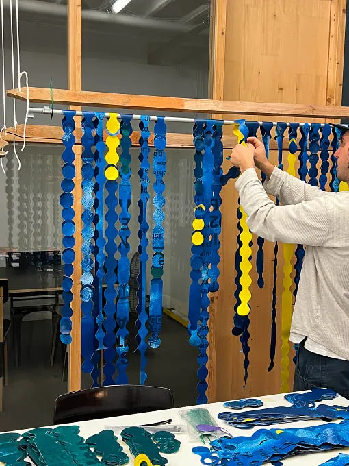 A man working on a string art project