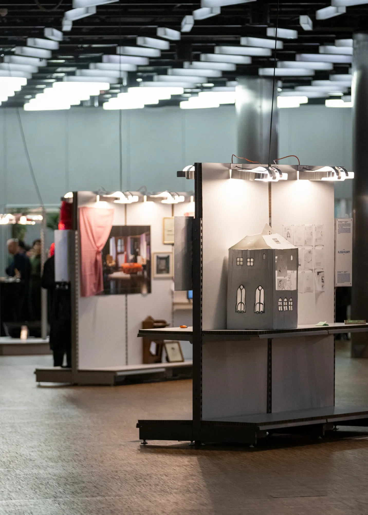 A module displaying a white house model, with other lit modules behind.