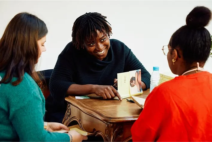 A group of women sitting around a wooden table