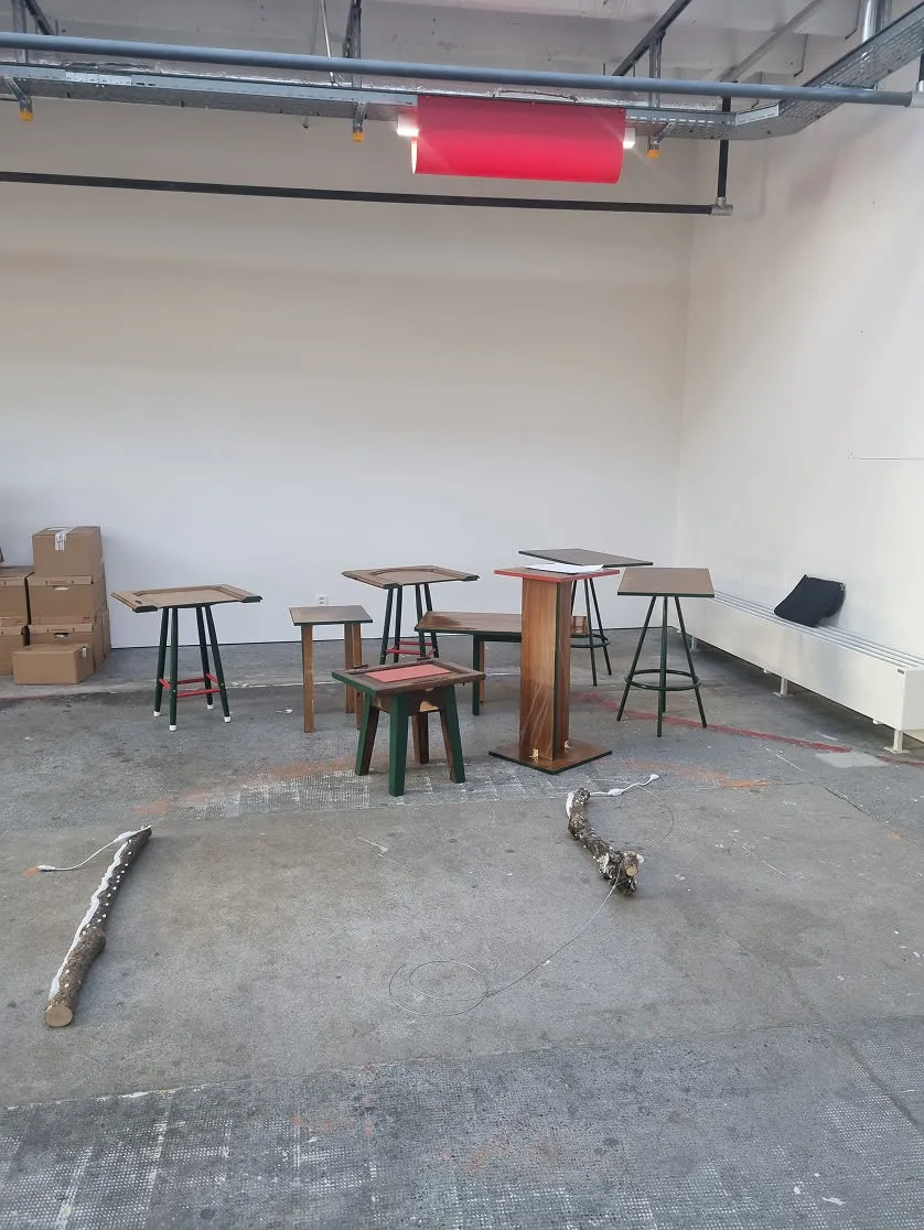 A room with several tables and stools in it