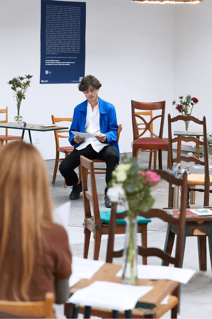 A woman sitting at a table reading a book