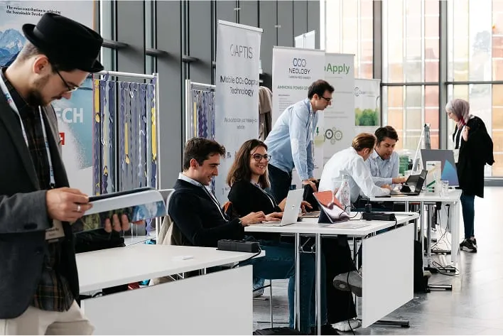 A group of people sitting at desks in a room