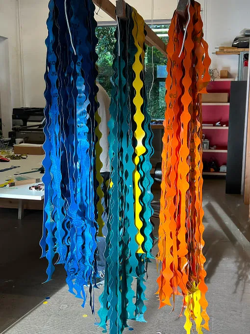 A group of colorful streamers hanging from a ceiling