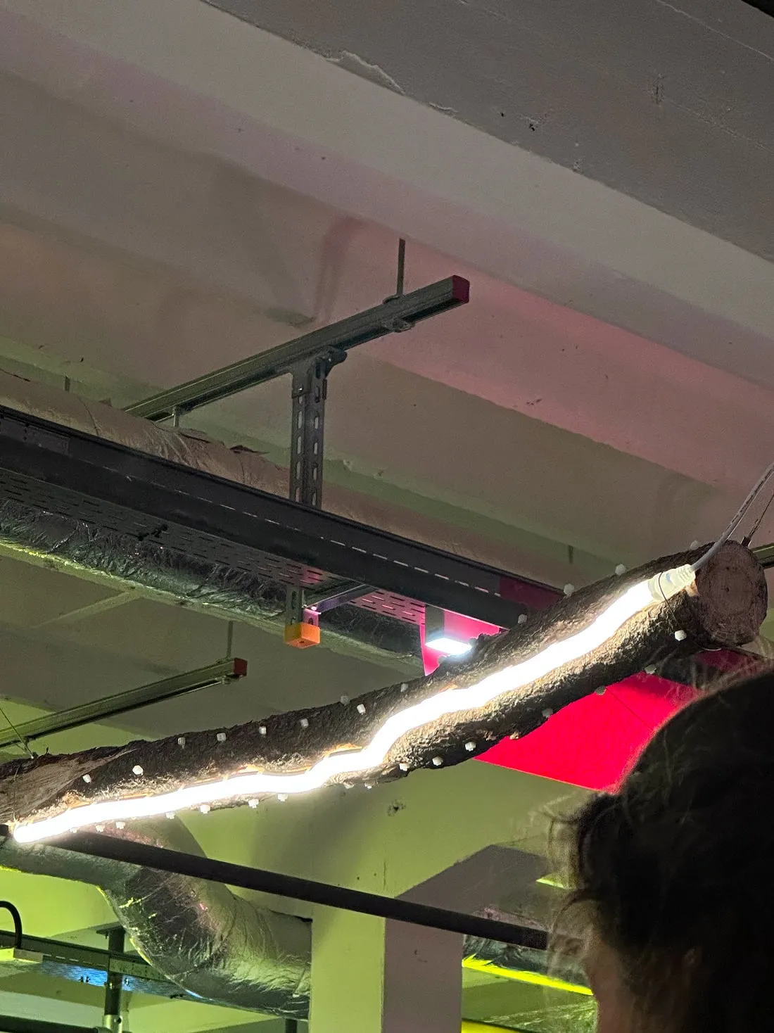A metal object suspended from the ceiling of a building