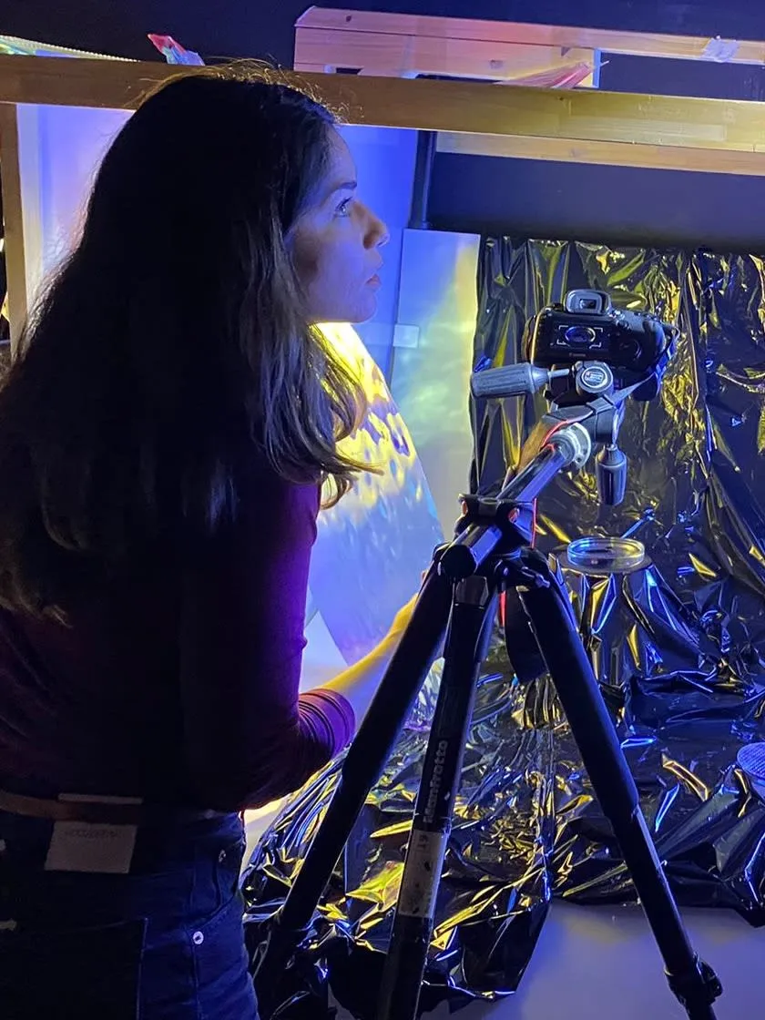 Karen Pisoni preparing the set for a studio shoot, for the Innovation by Design Challenge.