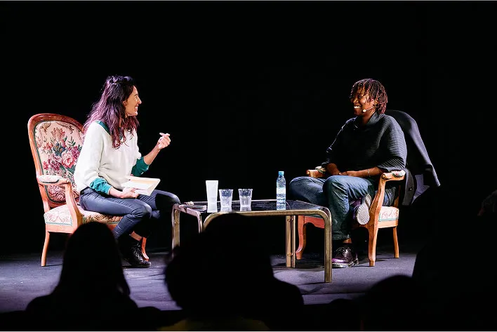 Two women sitting on chairs talking to each other