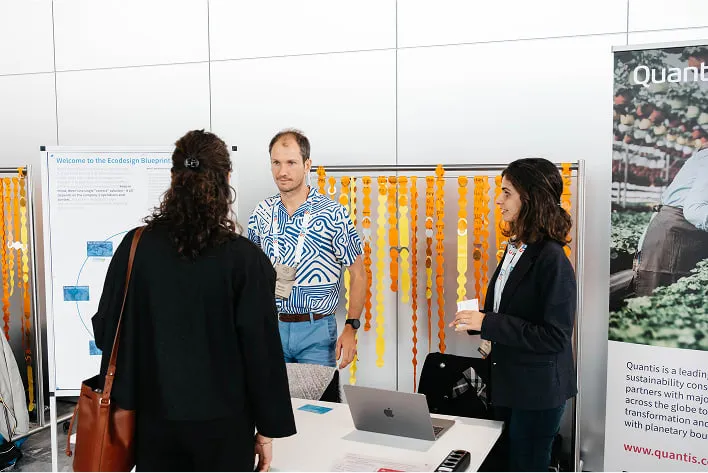 A group of people standing around a table