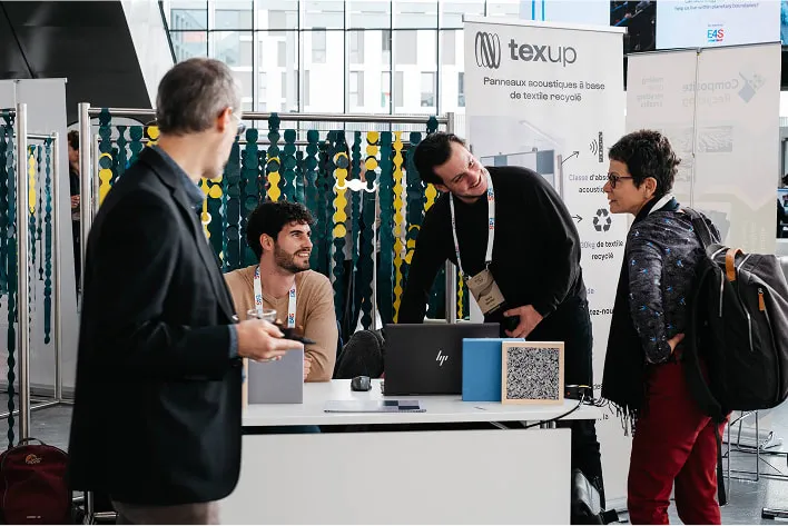A group of men standing around a table