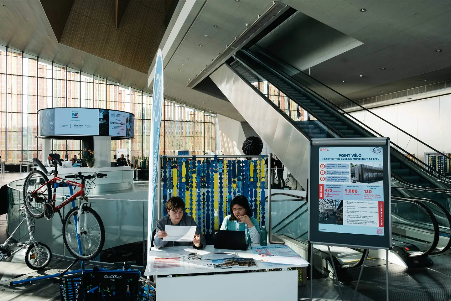 A couple of people sitting at a table with a laptop