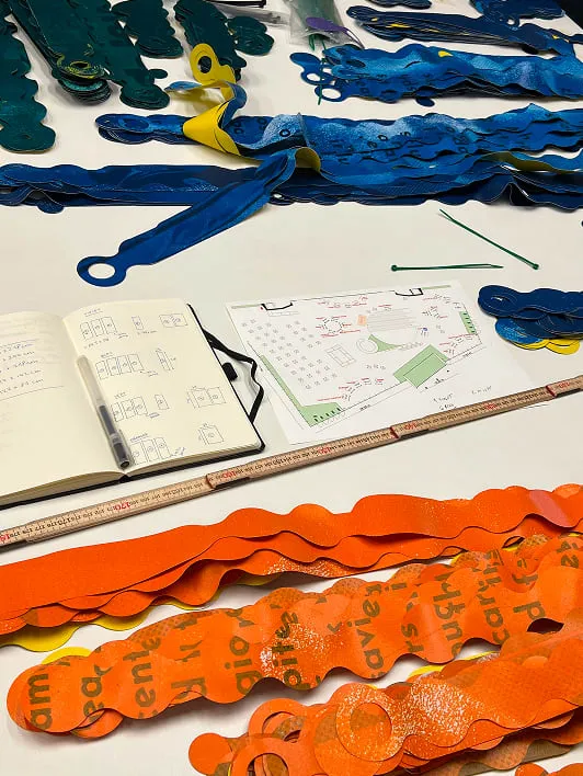 A table topped with lots of orange and blue scissors